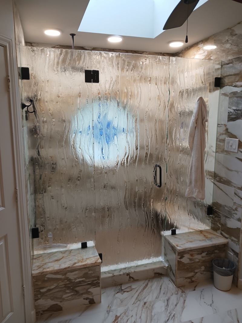 Custom frameless shower door installation by Artisan Glass Designs in DFW