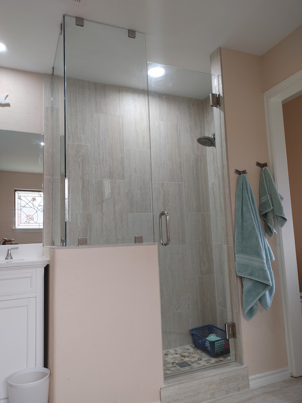 Custom frameless shower door installation by Artisan Glass Designs in DFW